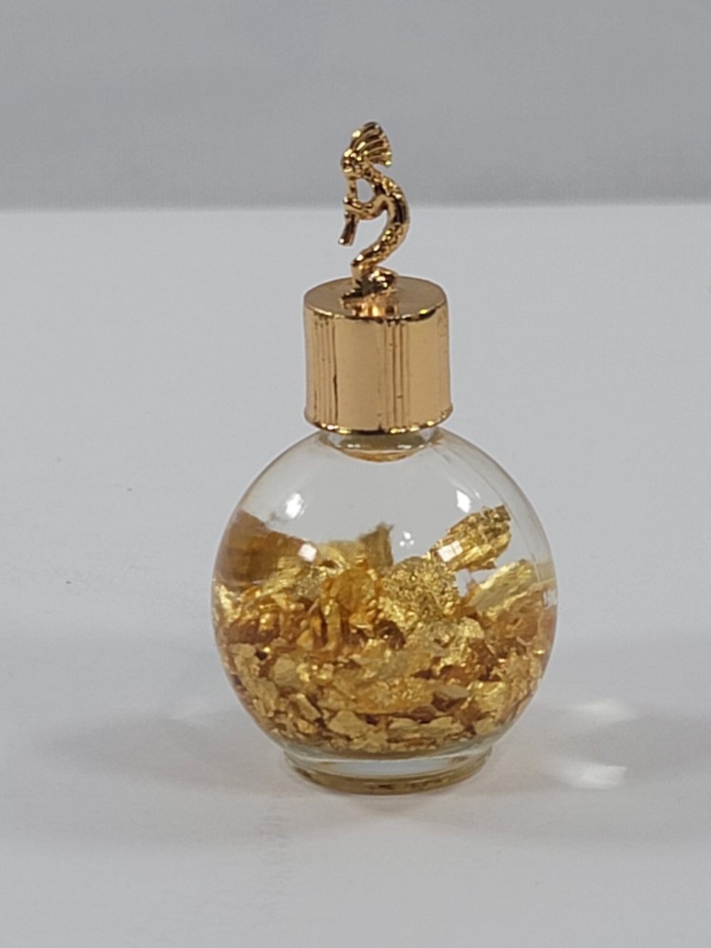 Souvenir Bottle Of Genuine Gold Flakes in Water Flute Player Topper